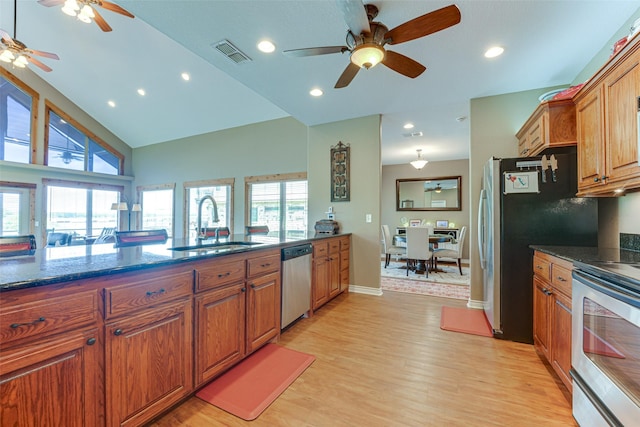5553 Lakeshore Ct, Log Cabin, TX 75148 - kitchen with a sink, brown cabinetry, stainless steel appliances, a ceiling fan, and visible vents