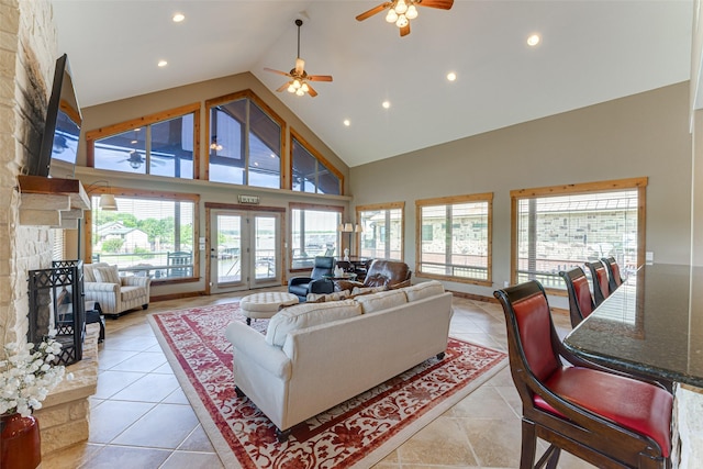 5553 Lakeshore Ct, Log Cabin, TX 75148 - living area featuring light tile patterned flooring, a stone fireplace, high vaulted ceiling, recessed lighting, and a ceiling fan