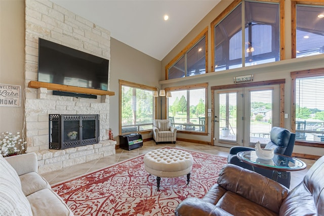 5553 Lakeshore Ct, Log Cabin, TX 75148 - living area featuring tile patterned flooring, a stone fireplace, high vaulted ceiling, recessed lighting, and french doors