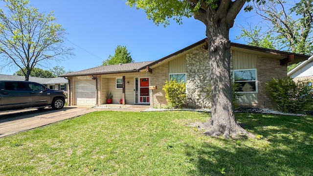 view of front of house featuring an attached garage, a front lawn, driveway, and stone siding