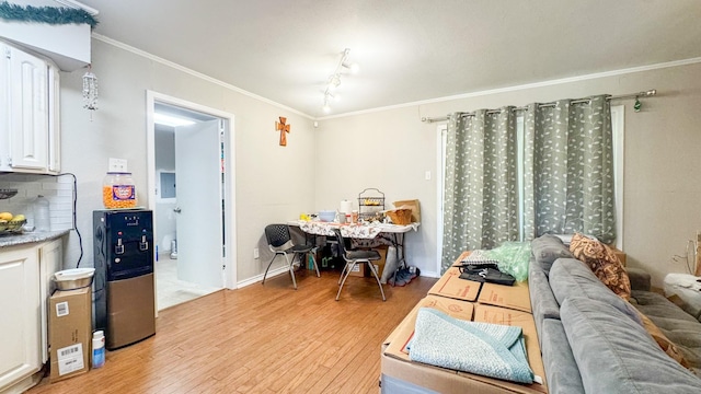 interior space featuring light wood-style floors and crown molding