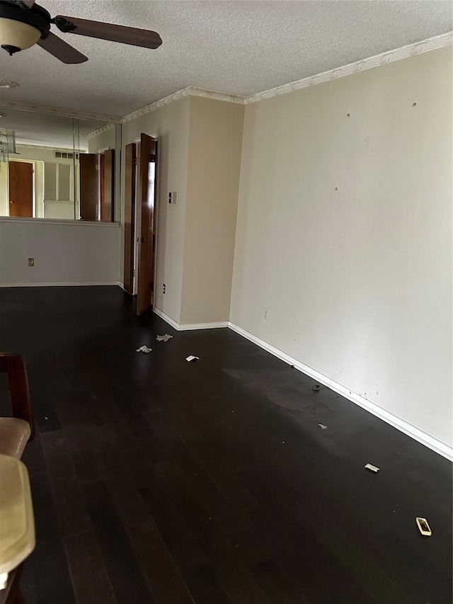 unfurnished living room with baseboards, a textured ceiling, ceiling fan, and wood finished floors