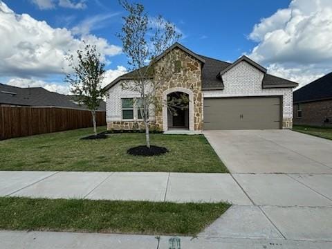 1109 Colonial Bluff Ln, Princeton, TX 75407 - french provincial home featuring a front lawn, fence, stone siding, concrete driveway, and an attached garage