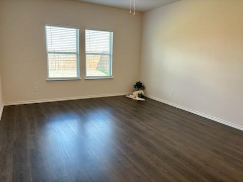 1109 Colonial Bluff Ln, Princeton, TX 75407 - unfurnished room featuring baseboards and dark wood-type flooring
