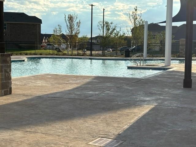 1109 Colonial Bluff Ln, Princeton, TX 75407 - community pool with fence and a patio