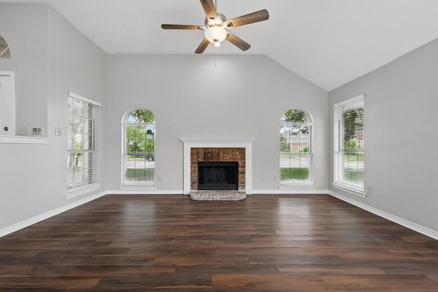 unfurnished living room with ceiling fan, a fireplace with raised hearth, high vaulted ceiling, baseboards, and wood finished floors