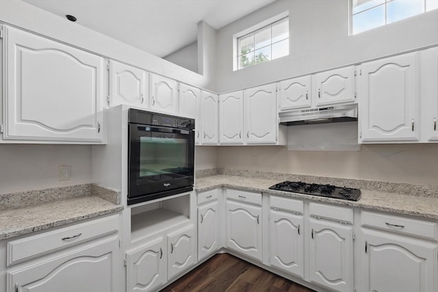 kitchen with under cabinet range hood, white cabinetry, a wealth of natural light, and black appliances