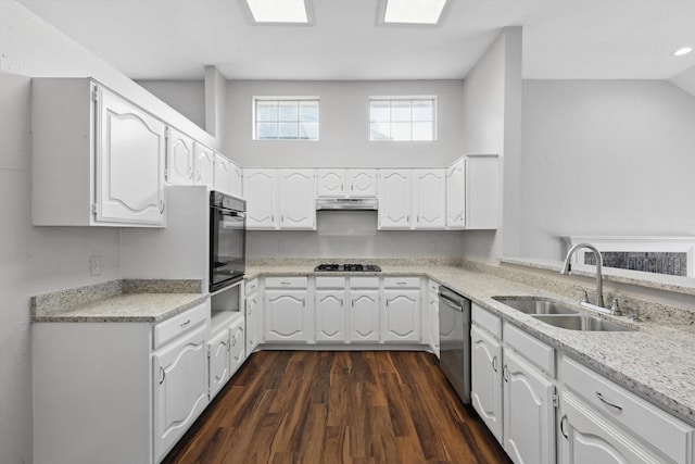 kitchen featuring stainless steel dishwasher, oven, dark wood-type flooring, white cabinetry, and a sink
