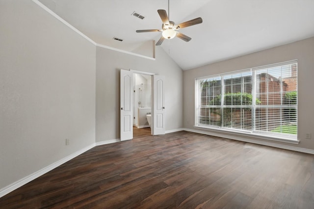 unfurnished bedroom featuring baseboards, visible vents, dark wood finished floors, and lofted ceiling