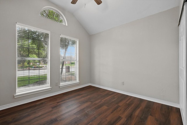 empty room with baseboards, a ceiling fan, dark wood-style flooring, and lofted ceiling