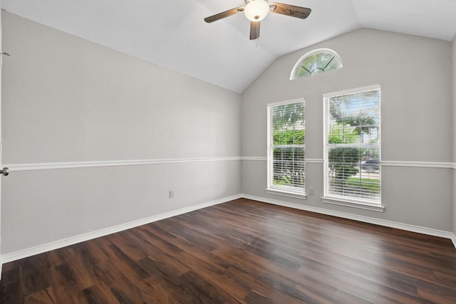 empty room with wood finished floors, a ceiling fan, baseboards, and lofted ceiling