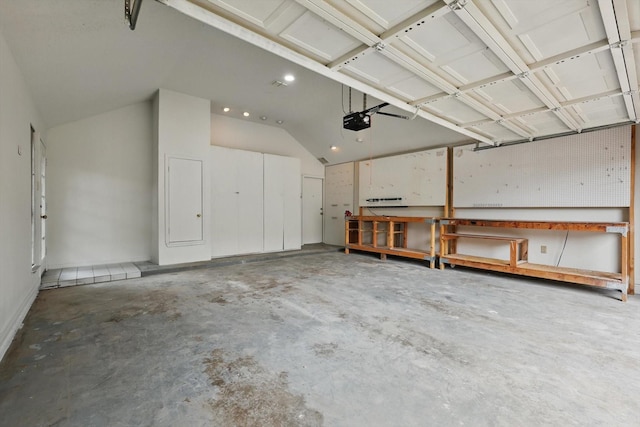 garage featuring a workshop area, a garage door opener, and recessed lighting