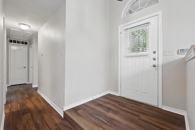 entryway with dark wood-type flooring, baseboards, and visible vents