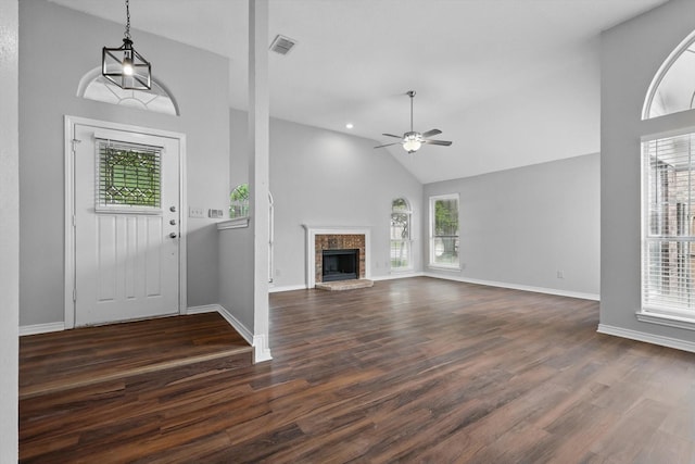 foyer entrance featuring plenty of natural light, a ceiling fan, dark wood-style floors, and visible vents