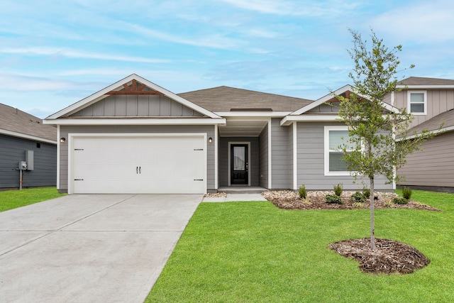 view of front of house with an attached garage, a front lawn, board and batten siding, and driveway