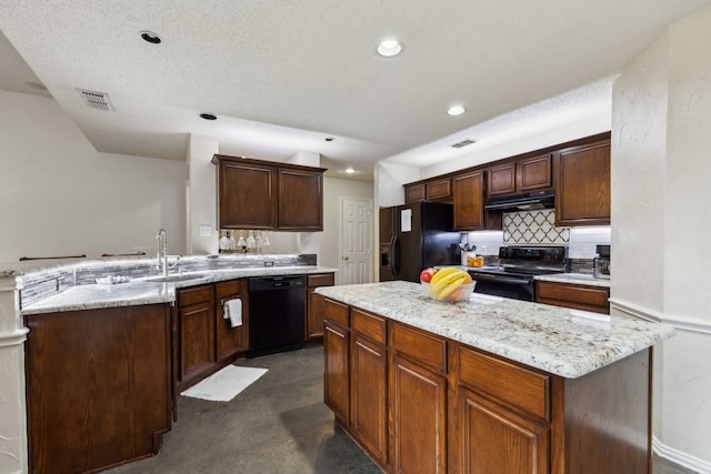 kitchen featuring visible vents, recessed lighting, a center island, a sink, and black appliances