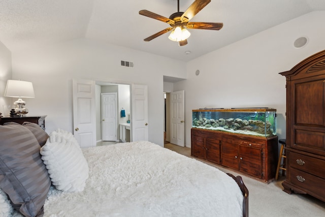 bedroom featuring visible vents, a ceiling fan, lofted ceiling, and light carpet