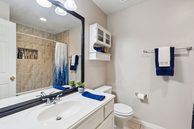 full bathroom with vanity, tile patterned flooring, curtained shower, toilet, and a textured ceiling
