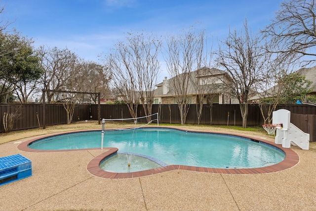 view of swimming pool featuring a fenced backyard and a pool with connected hot tub
