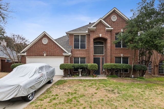 traditional home featuring brick siding, a garage, and a front yard
