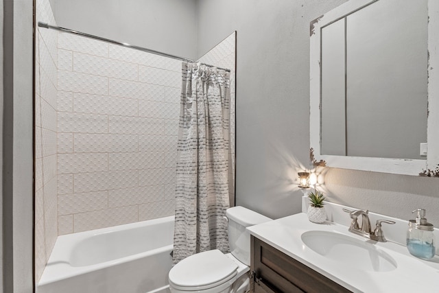 full bathroom with vanity, a textured wall, shower / bath combo, and toilet