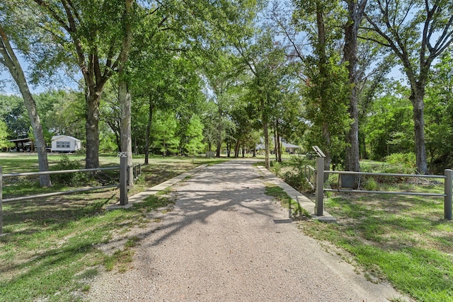 surrounding community with fence and driveway