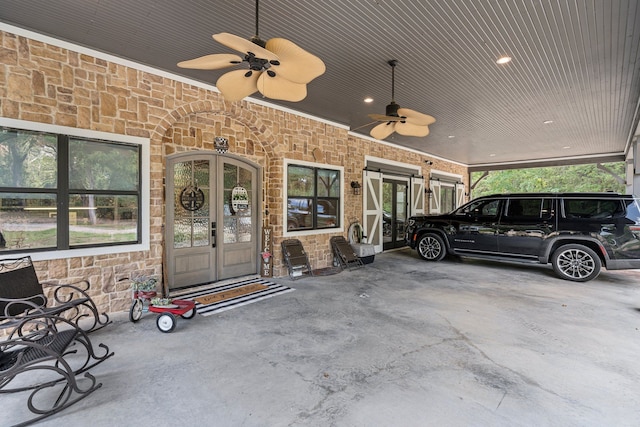 exterior space featuring a ceiling fan, french doors, stone siding, and a carport