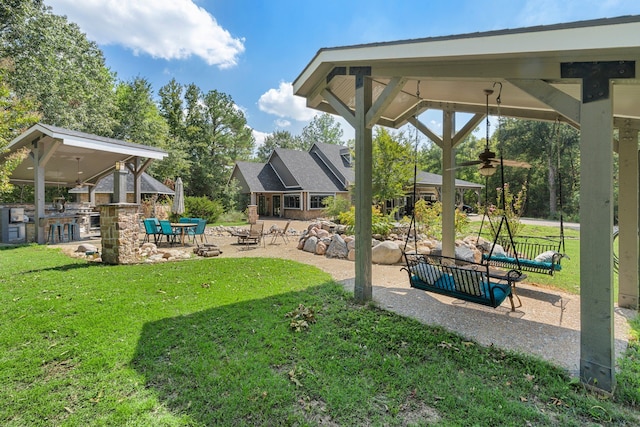 view of yard featuring area for grilling, a gazebo, a fire pit, and a patio area