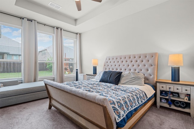 7210 Rustic Rock Rd, Arlington, TX 76001 - carpeted bedroom featuring a tray ceiling, visible vents, and ceiling fan