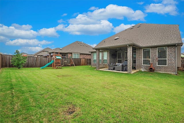 7210 Rustic Rock Rd, Arlington, TX 76001 - rear view of property featuring a playground, an outdoor living space, a fenced backyard, and brick siding