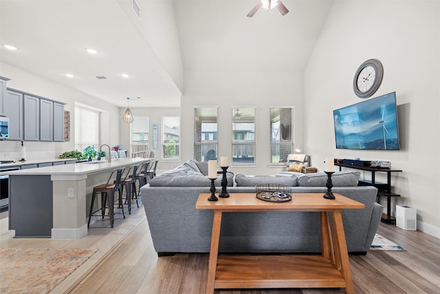 7210 Rustic Rock Rd, Arlington, TX 76001 - living area featuring high vaulted ceiling, a ceiling fan, light wood finished floors, and visible vents