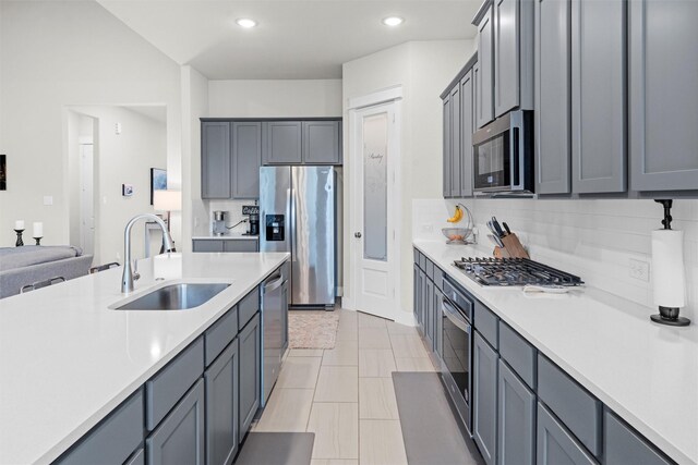 7210 Rustic Rock Rd, Arlington, TX 76001 - kitchen with open floor plan, recessed lighting, light countertops, a sink, and appliances with stainless steel finishes