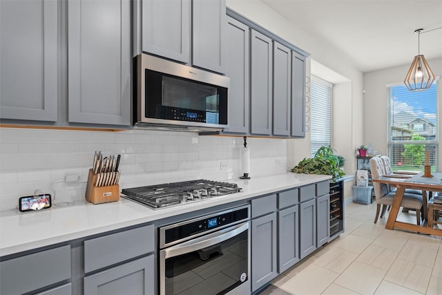 7210 Rustic Rock Rd, Arlington, TX 76001 - kitchen with wine cooler, a breakfast bar, a center island with sink, a sink, and appliances with stainless steel finishes