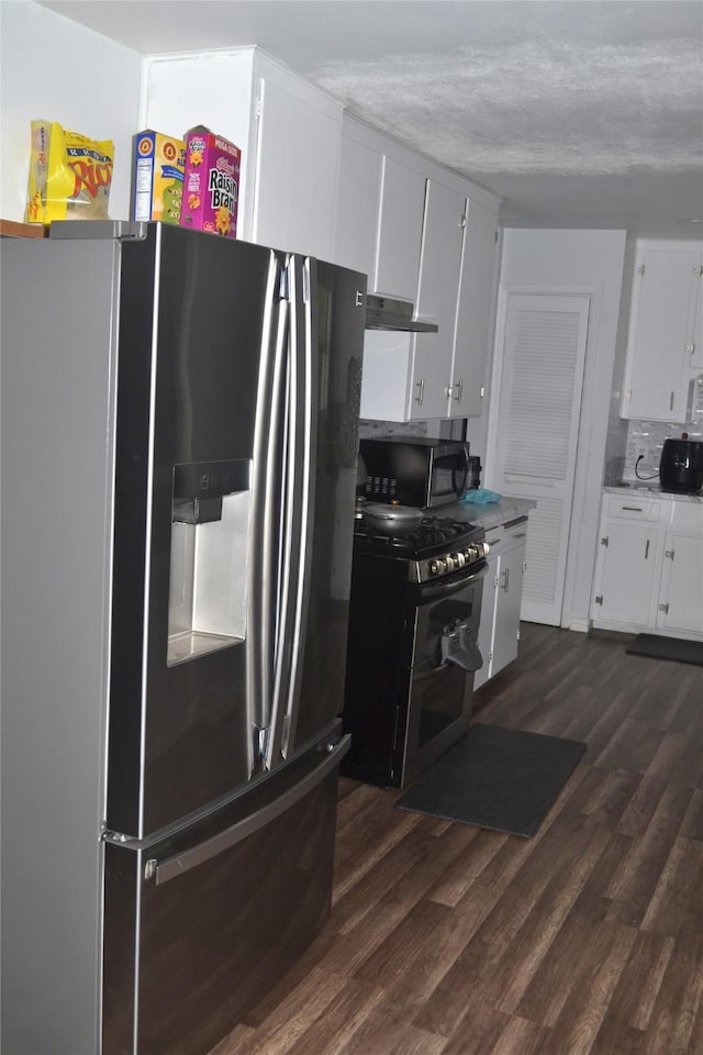 372 Shoreline Dr, Azle, TX 76020 - kitchen featuring appliances with stainless steel finishes, light countertops, white cabinets, dark wood-style floors, and under cabinet range hood