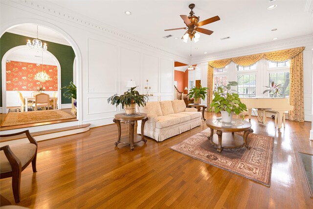 1204 Lakeridge Dr, Ennis, TX 75119 - living area featuring crown molding, arched walkways, a decorative wall, and ceiling fan with notable chandelier
