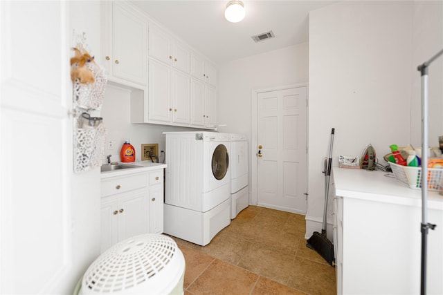 1204 Lakeridge Dr, Ennis, TX 75119 - laundry room with visible vents, a sink, cabinet space, and washer and dryer