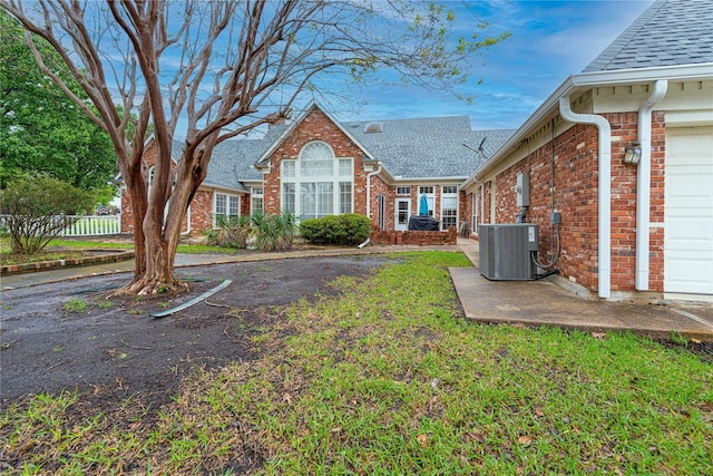 1204 Lakeridge Dr, Ennis, TX 75119 - exterior space featuring fence, an attached garage, and cooling unit