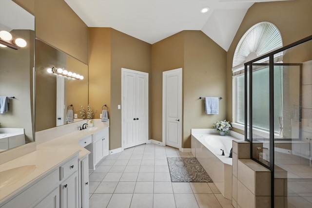 full bathroom with a garden tub, tile patterned flooring, two vanities, a sink, and a stall shower