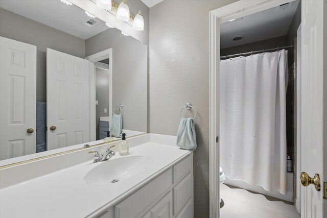 bathroom with vanity, tile patterned floors, toilet, and visible vents