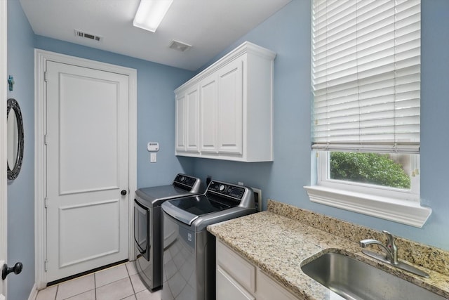 laundry room with visible vents, a sink, cabinet space, and washer and dryer