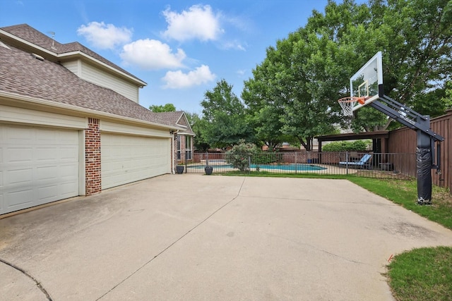 exterior space with a fenced in pool and fence
