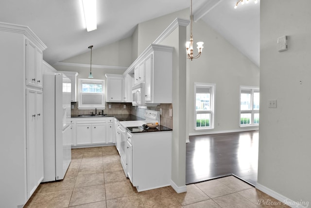 9518 Hackberry Dr, Shreveport, LA 71115 - kitchen featuring white appliances, light tile patterned floors, dark countertops, and a sink
