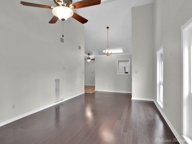 9518 Hackberry Dr, Shreveport, LA 71115 - unfurnished living room featuring visible vents, dark wood-type flooring, ceiling fan with notable chandelier, and high vaulted ceiling