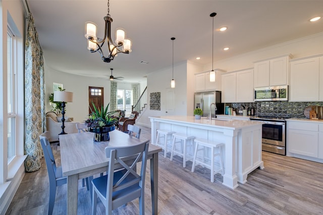 603 E Midway, Euless, TX 76039 - kitchen with light countertops, backsplash, stainless steel appliances, and light wood finished floors