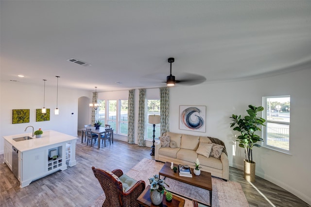 603 E Midway, Euless, TX 76039 - living area with light wood-style floors, baseboards, ceiling fan with notable chandelier, and visible vents
