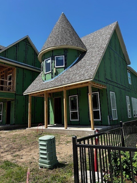 603 E Midway, Euless, TX 76039 - view of front of house featuring board and batten siding, fence, and a shingled roof