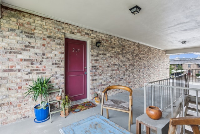 entrance to property featuring brick siding
