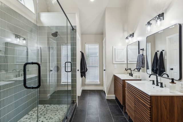 bathroom with a sink, tile patterned floors, two vanities, and a shower stall