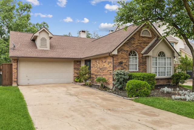single story home featuring driveway, a chimney, a garage, brick siding, and a shingled roof