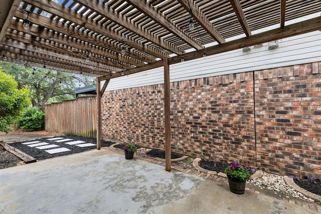 view of patio / terrace featuring fence and a pergola